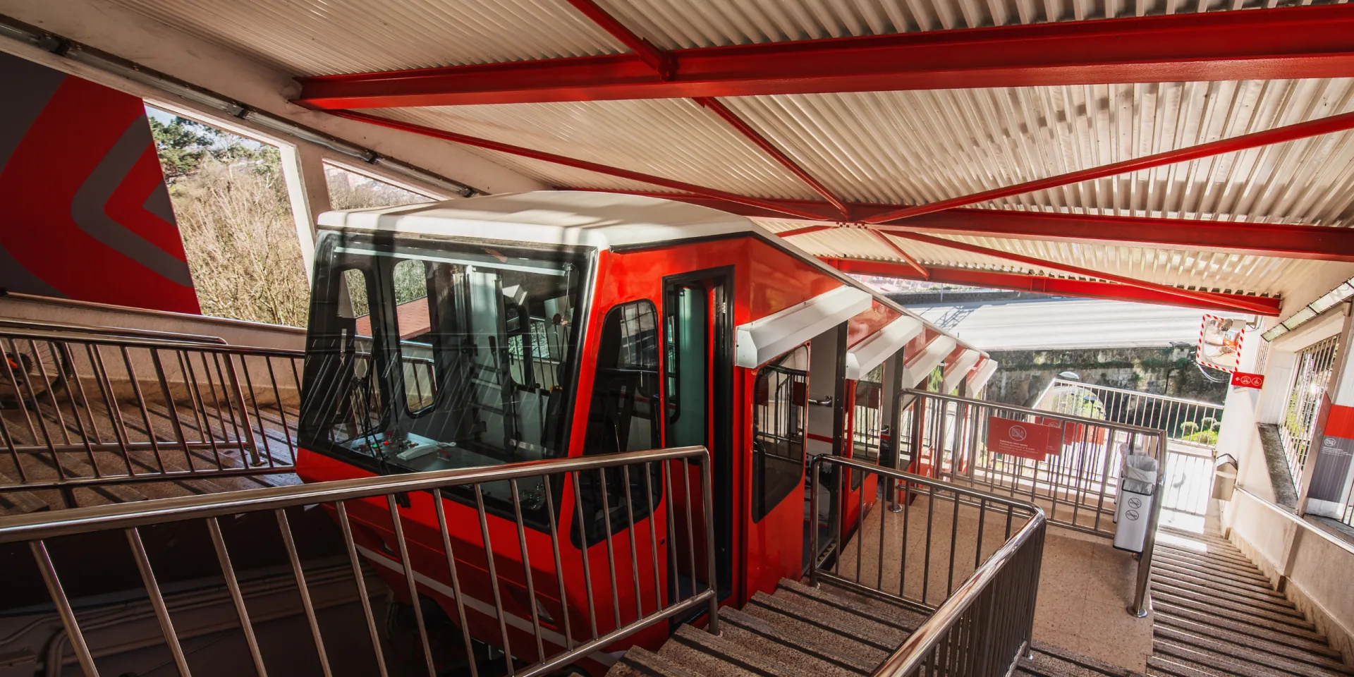 The Artxanda funicular car climbing its incline with the Bilbao skyline spread out below